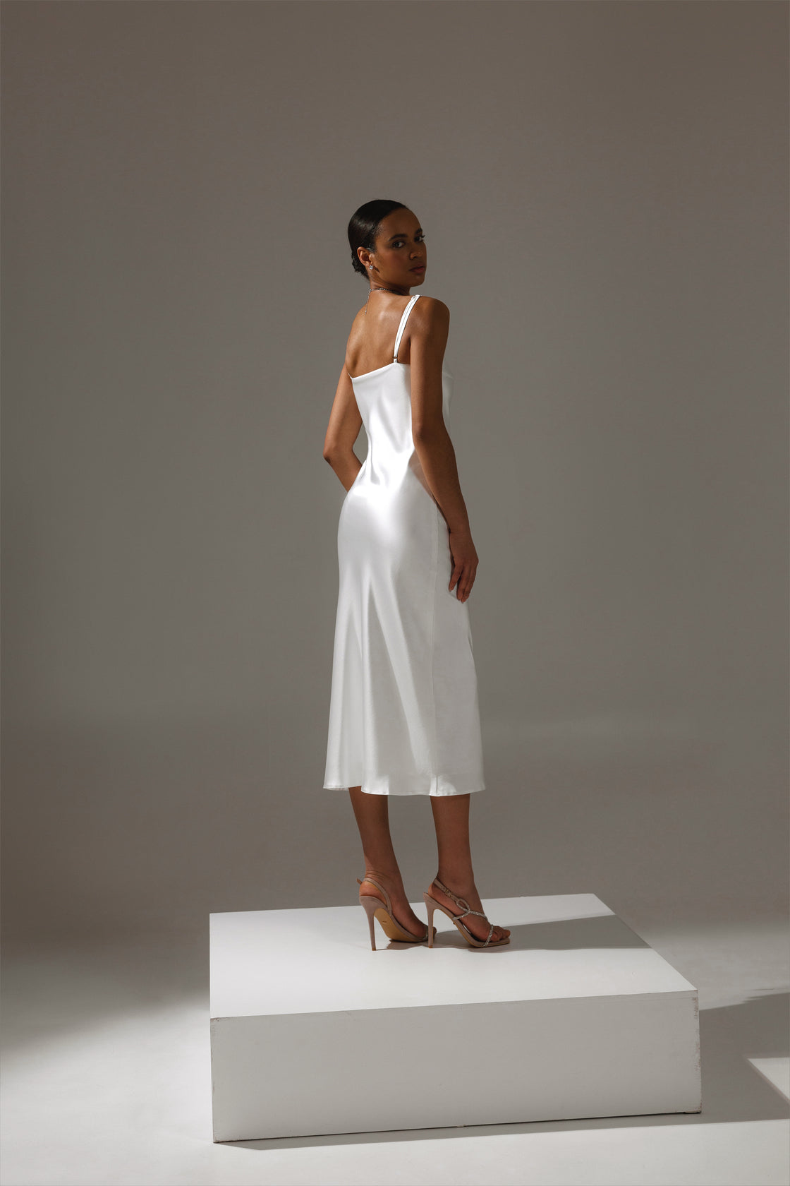 Back view of Lotos gown in motion – graceful drape and movement